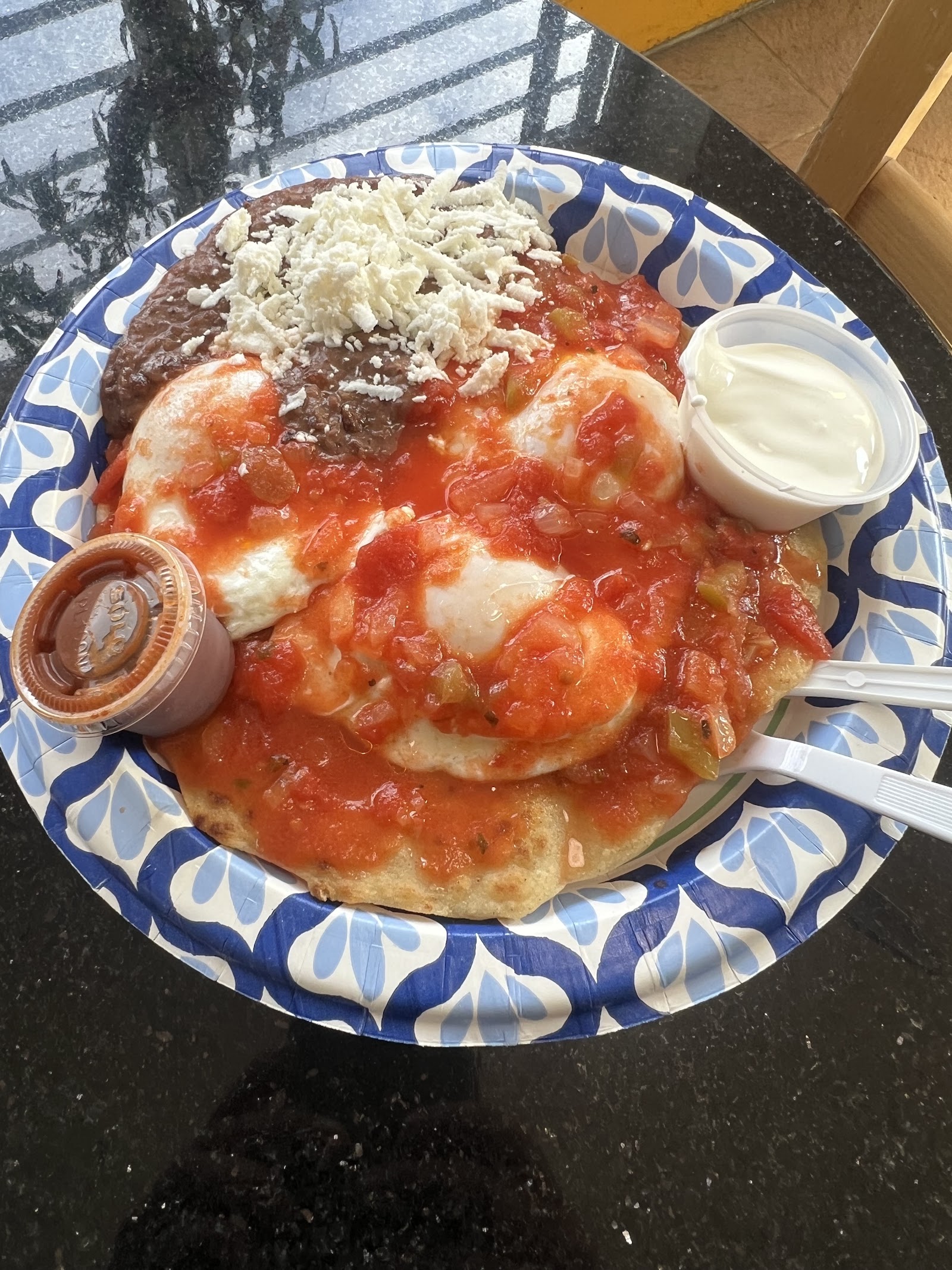 Huevos rancheros with red salsa and queso fresco