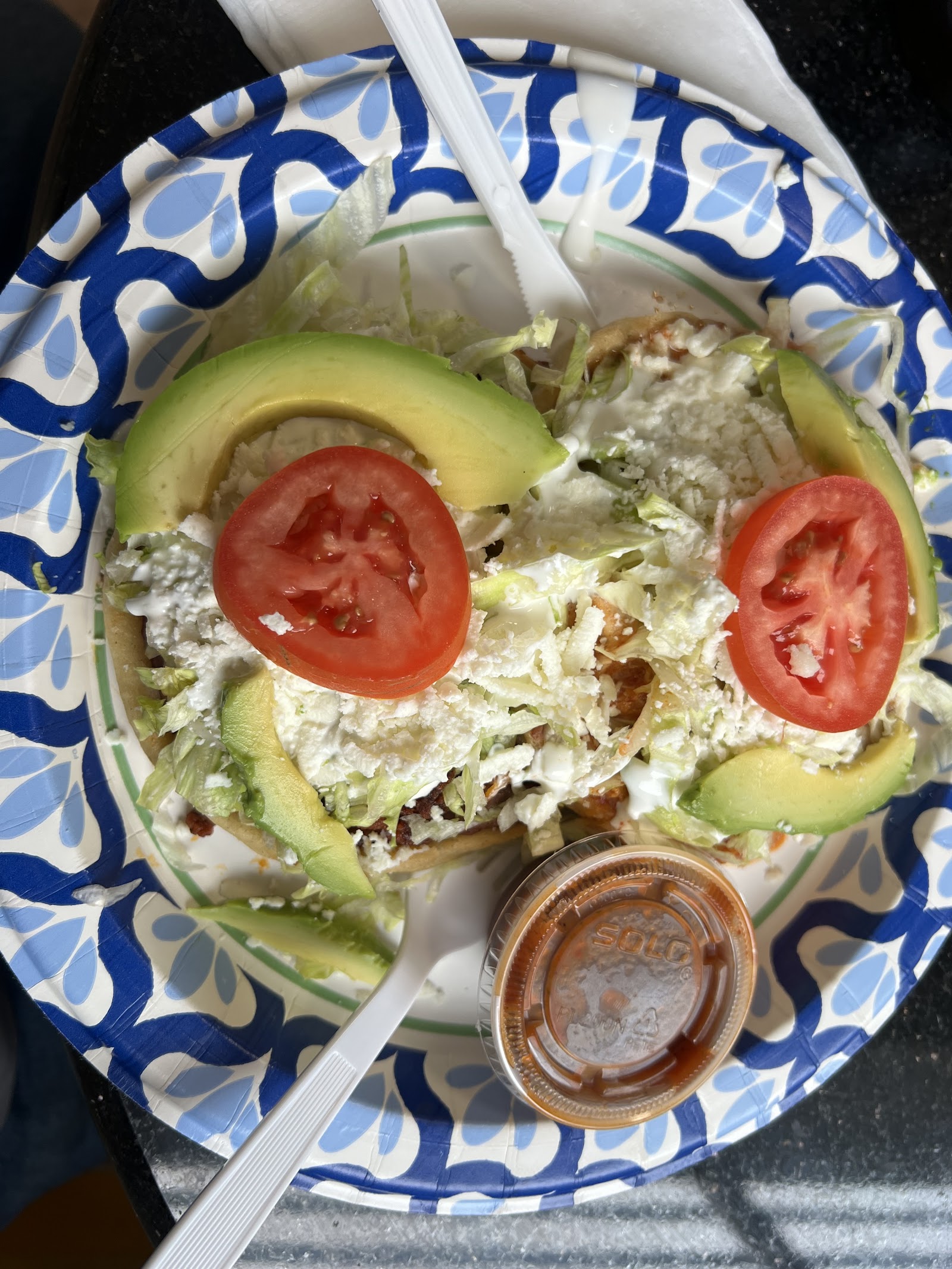 Tostada with avocado, queso, tomato